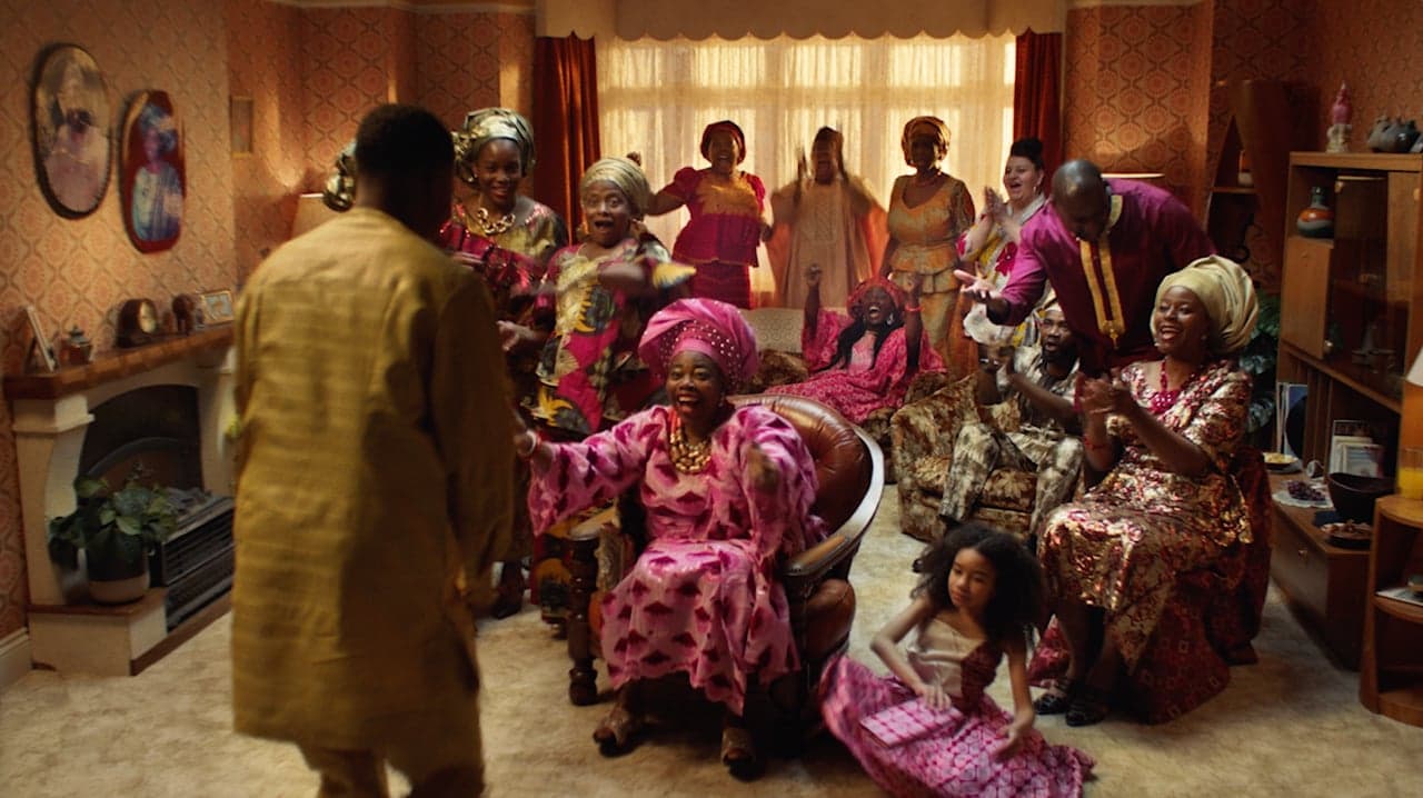 A family celebrates together in a living room in the Secret Language film.